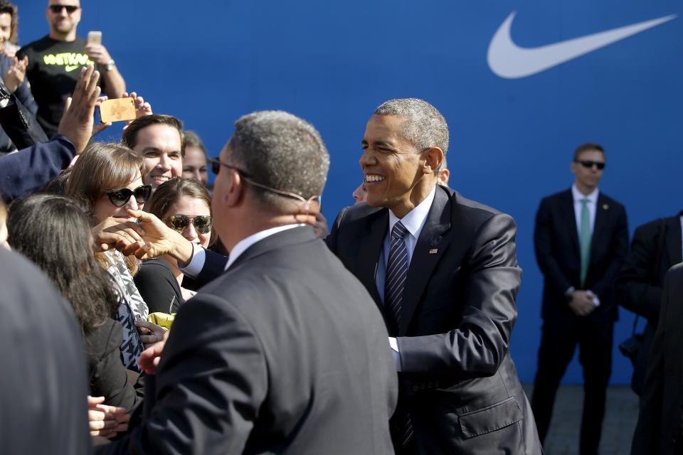 U.S. President Barack Obama greets employees as he arrives to deliver remarks on trade at Nike's corporate headquarters in Beaverton, Oregon May 8, 2015. Sports shoe maker Nike Inc put its weight behind Obama's push for a trade deal with Asian countries on Friday with a promise to create up to 10,000 U.S.-based manufacturing jobs if the pact is approved. REUTERS/Jonathan Ernst