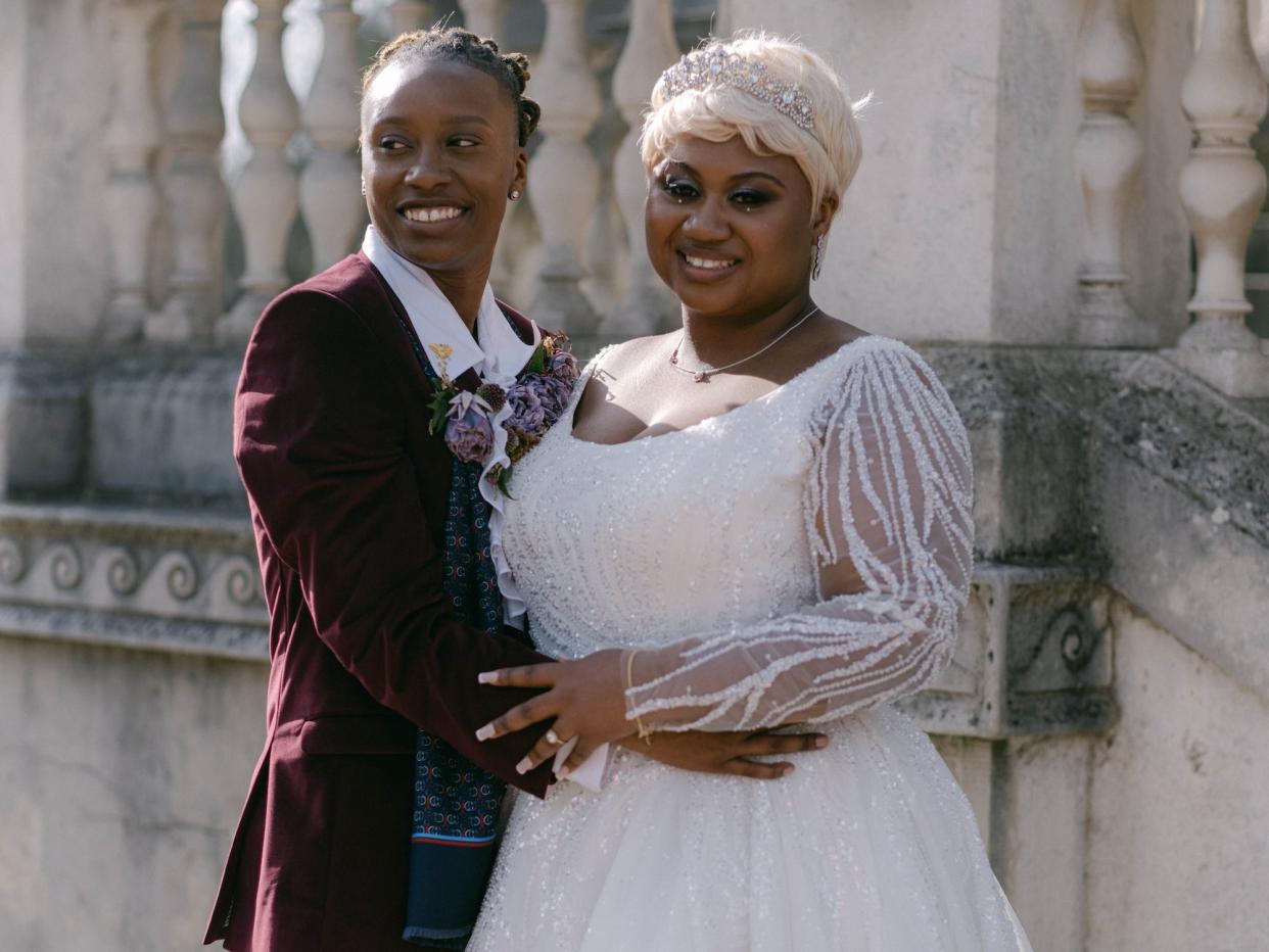 Shanti Hinton and Tiffany Rae pose in "Bridgerton" inspired wedding outfits.