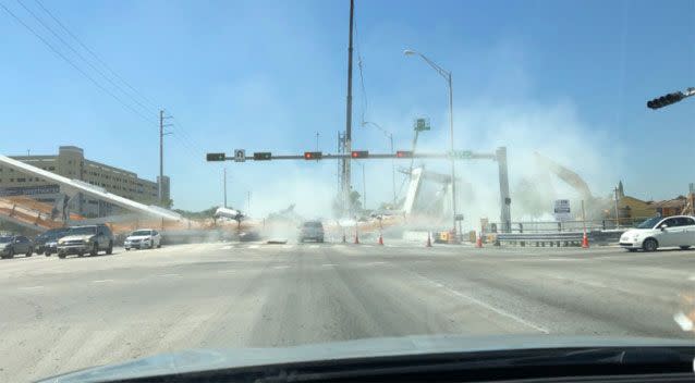 Witnesses' images showed a thick cloud of smoke immediately after the bridge collapsed. Source: Twitter/ meganmfernandez