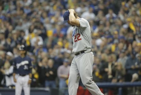 Oct 12, 2018; Milwaukee, WI, USA; Los Angeles Dodgers starting pitcher Clayton Kershaw (22) reacts after giving up a solo home run to Milwaukee Brewers relief pitcher Brandon Woodruff (53, not pictured) during the third inning against the Los Angeles Dodgers in game one of the 2018 NLCS playoff baseball series at Miller Park. Mandatory Credit: Jon Durr-USA TODAY Sports