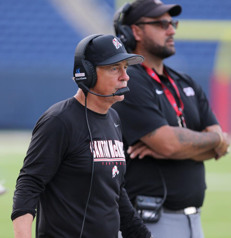 McKinley assistant coach Joe Tresey, left, looks on during their scrimmage against St. Ignatius at Tom Benson Hall of Fame Stadium on Friday, August 13, 2021. At right is head coach Antonio Hall.