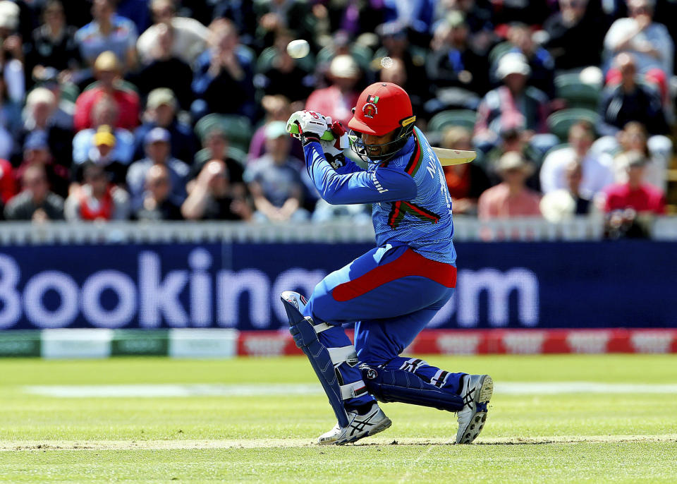Afghanistan's Noor Ali Zadran ducks for a bouncer during the ICC Cricket World Cup group stage match between Afghanistan and New Zealand at the County Ground Taunton, England, Saturday, June 8, 2019. (Mark Kerton/PA via AP)