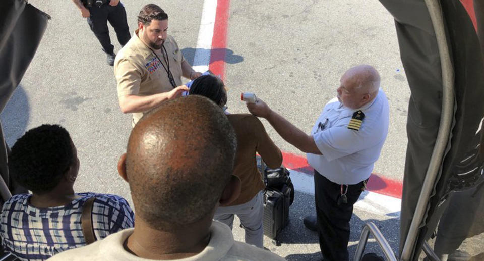 Passengers on Emirates flight EK203 had their temperature taken on the tarmac of New York's Kennedy airport