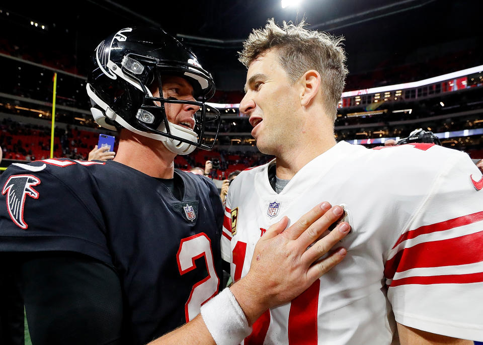 Eli Manning is surely trying to explain the Giants’ late-game clock management here to a befuddled Matt Ryan. (Getty)