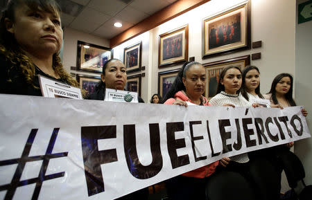 Relatives of people who went missing in 2009 display a banner that reads "It was the army" after a hearing convened by the judges of the Inter-American Court of Human Rights in San Jose, Costa Rica April 26, 2018. REUTERS/Juan Carlos Ulate