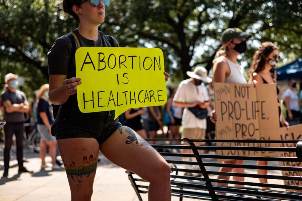 <span class="caption">Banning abortion can have health consequences for pregnant people.</span> <span class="attribution"><a class="link " href="https://www.gettyimages.com/detail/news-photo/woman-carries-a-sign-declaring-abortion-a-part-of-news-photo/1235196693" rel="nofollow noopener" target="_blank" data-ylk="slk:Jordan Vonderhaar/Stringer via Getty Images News;elm:context_link;itc:0;sec:content-canvas">Jordan Vonderhaar/Stringer via Getty Images News</a></span>