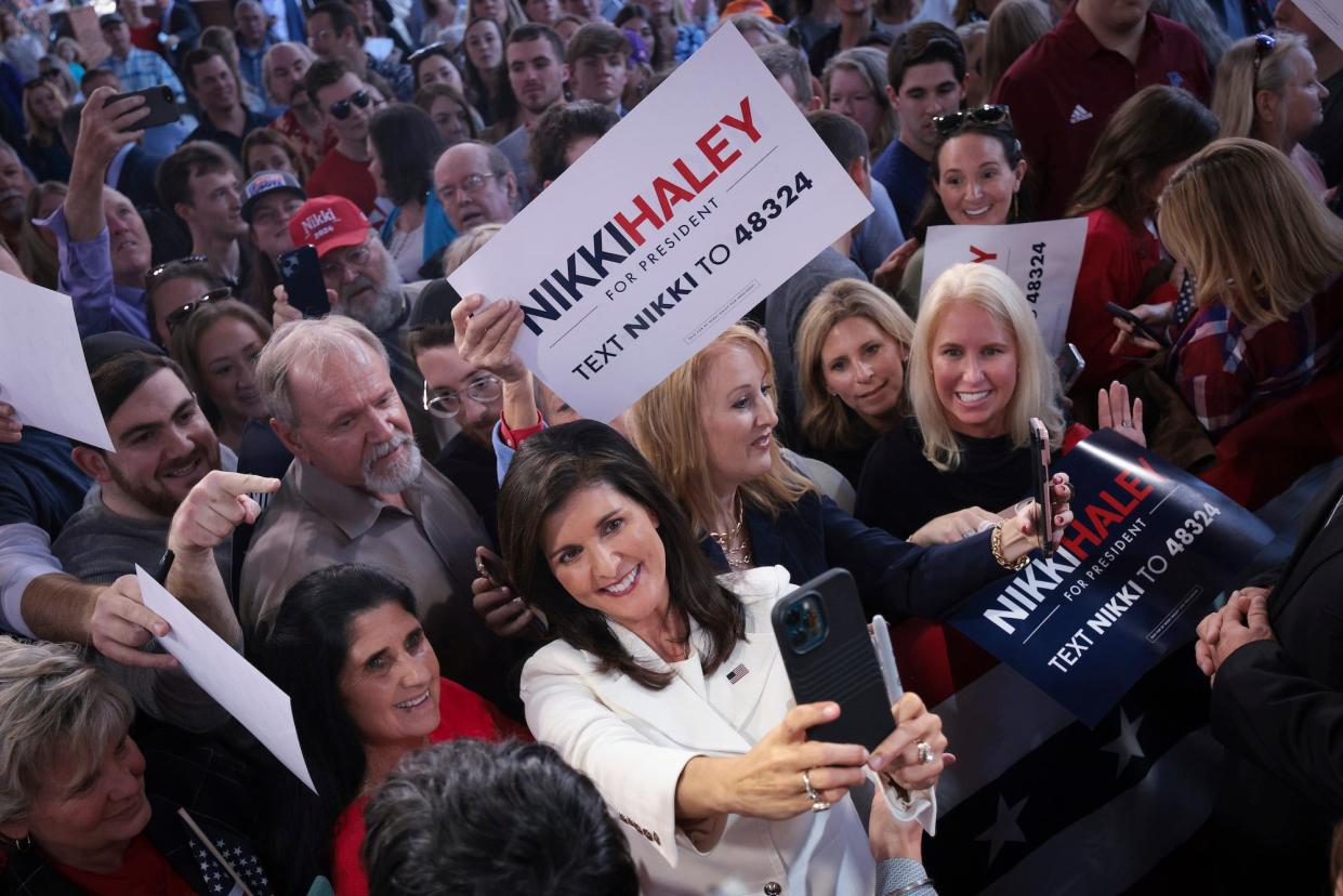 Former South Carolina governor turned 2024 Republican presidential candidate Nikki Haley takes a selfie with supporters at her first campaign event on February 15, 2023 in Charleston, South Carolina.