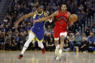 Toronto Raptors forward Scottie Barnes (4) drives to the basket against Golden State Warriors forward Jonathan Kuminga (00) during the first half of an NBA basketball game in San Francisco, Friday, Jan. 27, 2023. (AP Photo/Jed Jacobsohn)