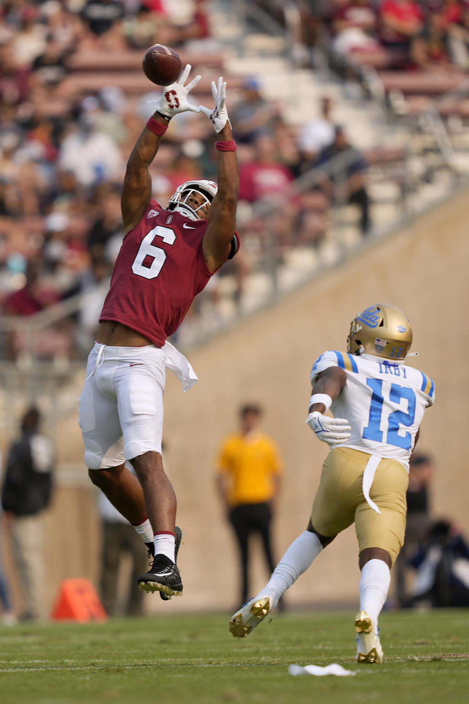 Stanford wide receiver Elijah Higgins (6) catches a pass over UCLA defensive back Martell Irby (12) during the first half of an NCAA college football game Saturday, Sept. 25, 2021, in Stanford, Calif. (AP Photo/Tony Avelar)