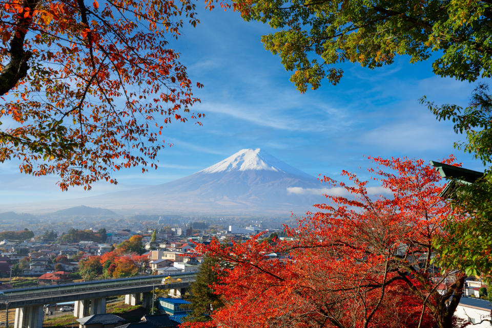 Fujiyoshida, Japan with fall foliage surrounding Mt. Fuji in autumn season.