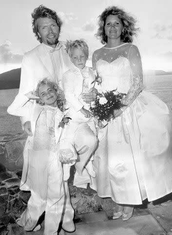 <p>PA Images/Getty</p> Richard Branson, Joan Templman, and their kids Holly and Sam, after their wedding on the Caribbean island of Necker.