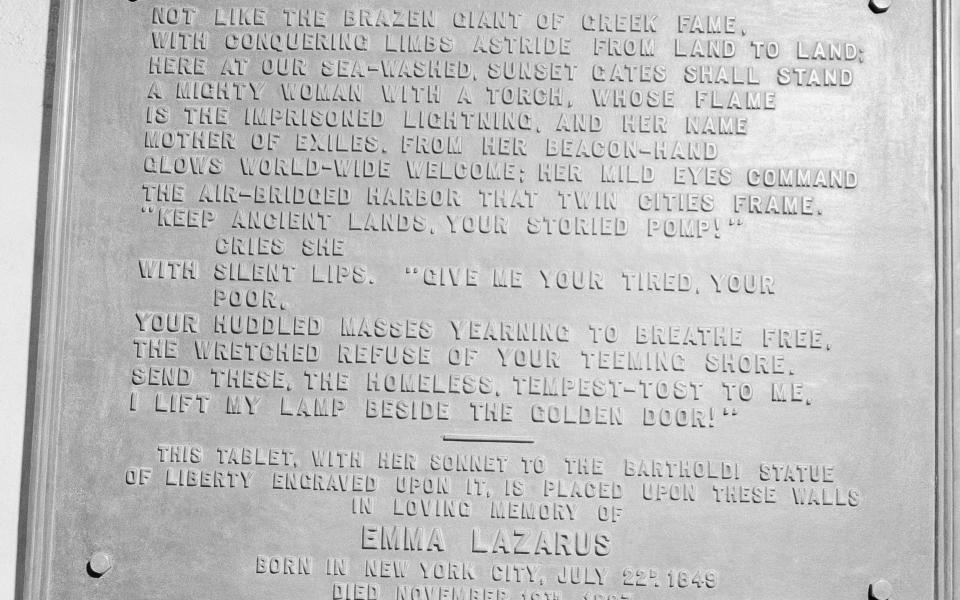 The bronze plaque of the poem by Poet Emma Lazurus on Statue of Liberty in New York - Credit: AP