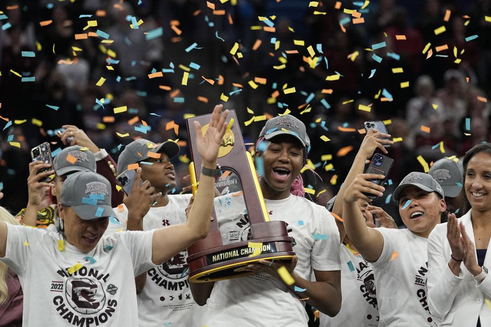 South Carolina’s Aliyah Boston holds the trophy after a college basketball game in the final round of the Women’s Final Four NCAA tournament against UConn Sunday, April 3, 2022, in Minneapolis. South Carolina won 64-49 to win the championship. (AP Photo/Eric Gay)