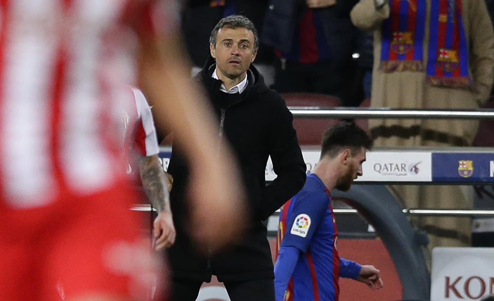 FC Barcelona's coach Luis Enrique, center, stands next Lionel Messi after been substituted during the Spanish La Liga soccer match between FC Barcelona and Sporting Gijon at the Camp Nou stadium in Barcelona, Spain, Wednesday, March 1, 2017. Luis Enrique says he will not stay as Barcelona coach after this season. The surprise announcement was made following the team’s 6-1 win over Sporting Gijon in the Spanish league on Wednesday. (AP Photo/Manu Fernandez)