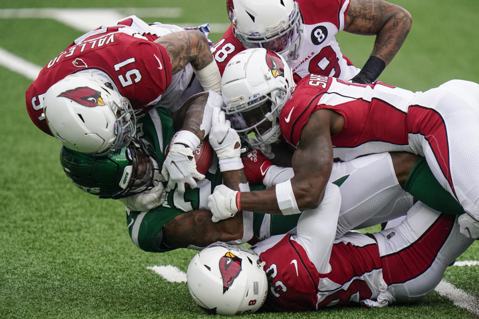 New York Jets running back La'Mical Perine, lower left, is tackled by a group of Arizona Cardinals defenders. (AP Photo/Frank Franklin II)