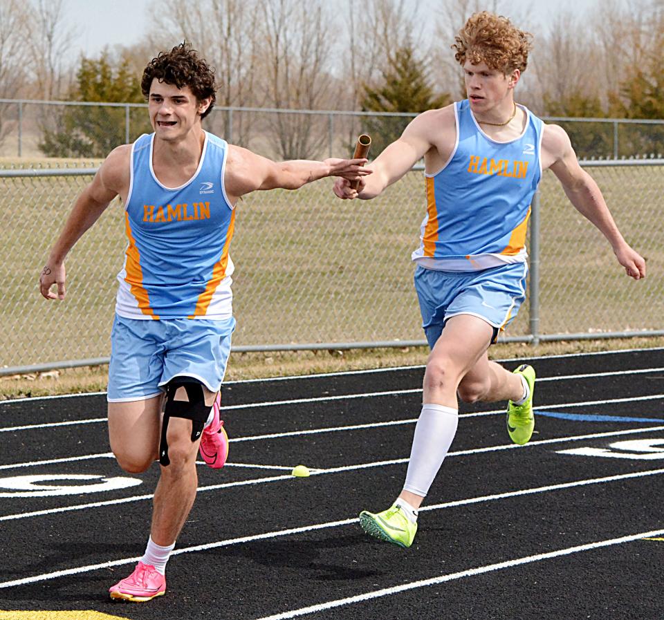 Hamlin's Luke Fraser passes the baton to teammate Gavin Prouty in the boys' 800-meter relay during the Pat Gilligan Alumni track and field meet on Tuesday, April 25, 2023 in Estelline.