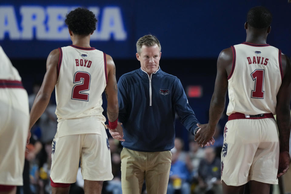Florida Atlantic head coach Dusty May claps hands with guards Johnell Davis (1) and Nicholas Boyd (2) during the first half of an NCAA college basketball game, Tuesday, Nov. 14, 2023, in Boca Raton, Fla. (AP Photo/Rebecca Blackwell)