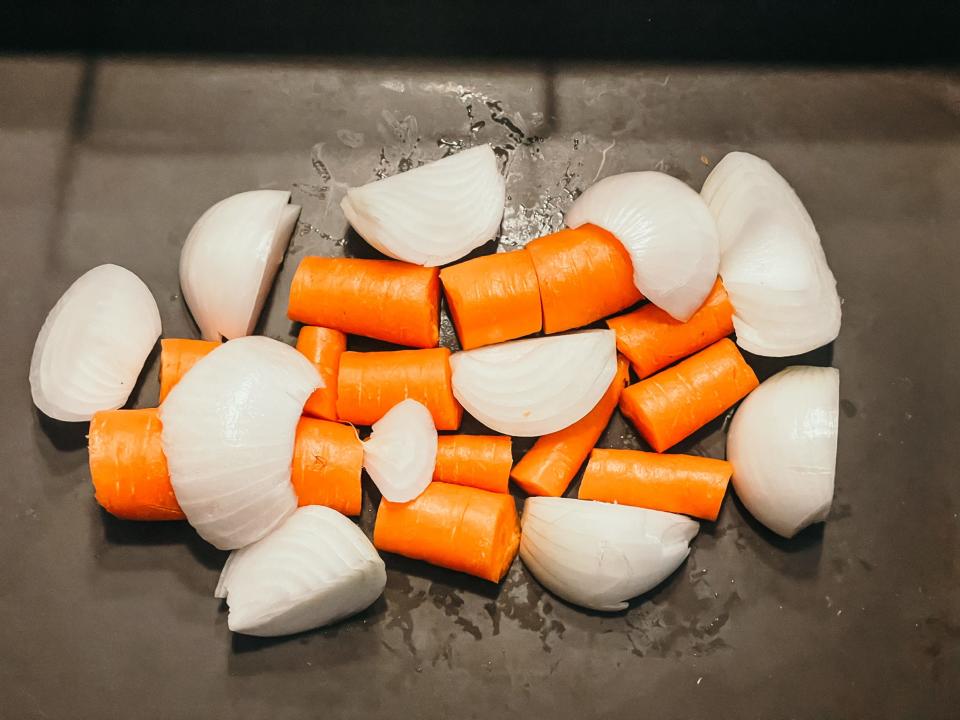 chopped onions and carrots in a pan