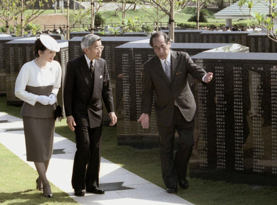 In this Aug. 1995 photo, Emperor Akihito, center, and Empress Michiko, left, visit before the Peace Wall monument bearing the names of those who were killed in the battle of Okinawa as the imperial couple pays a pilgrimage in Naha. During his father Hirohito’s reign, Akihito himself was almost hit by a molotov cocktail on a 1975 visit to Japan’s southern Okinawa island, where tens of thousands of civilians died in intense fighting near the end of World War II. He has since visited the island 10 times. Okinawans warmly welcomed him and his wife Michiko earlier this year in what was likely his last as emperor. (Kyodo News via AP)