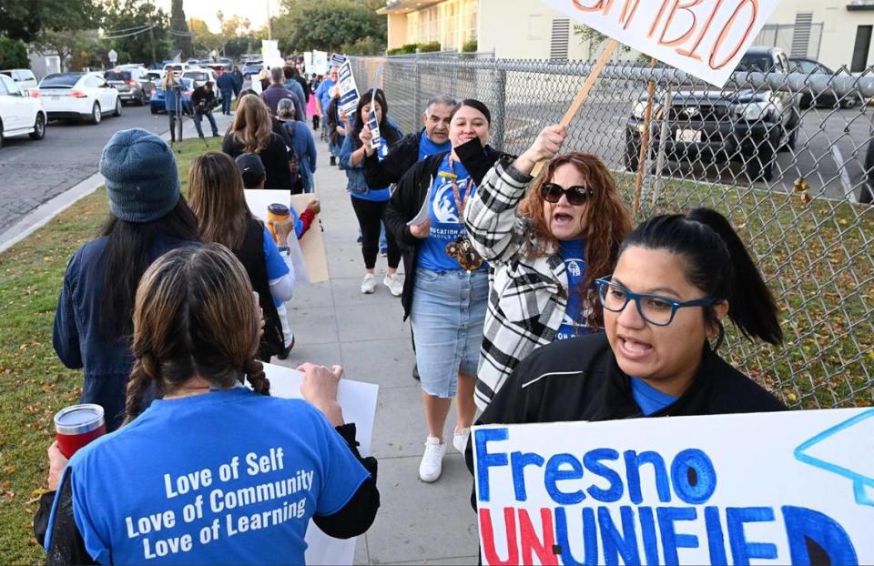 Teachers, supporting parents and their families, numbering close to 100, march in front of Winchell Elementary School in south Fresno as part of Fresno Teachers Association’s Day of Action Friday morning, Oct. 27, 2023 in Fresno. FTA intends to strike on Wednesday Nov. 1 if no agreement is reached.
