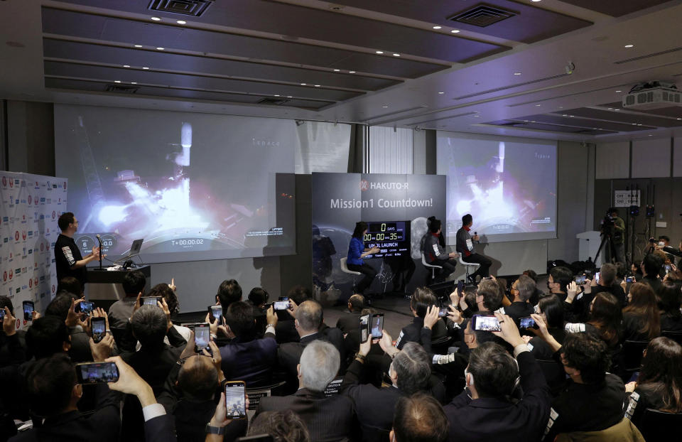 Officials of ispace Inc's HAKUTO-R mission look at live broadcasting of the launch of a SpaceX Falcon 9 rocket for ispace at Cape Canaveral Space Force Station, in Tokyo, Japan December 11, 2022. Mandatory credit Kyodo via REUTERS ATTENTION EDITORS - THIS IMAGE WAS PROVIDED BY A THIRD PARTY. MANDATORY CREDIT. JAPAN OUT. NO COMMERCIAL OR EDITORIAL SALES IN JAPAN