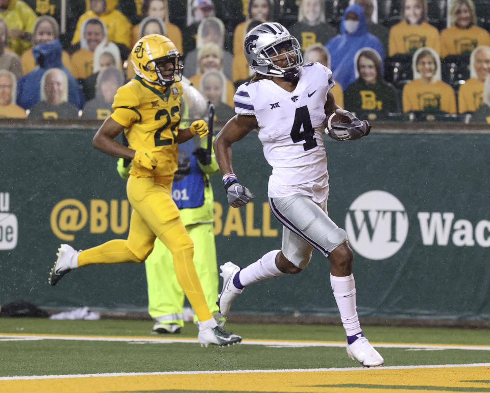 Kansas State wide receiver Malik Knowles (4) scores a touchdown past Baylor safety JT Woods (22) during the first half of an NCAA college football game Saturday, Nov. 28, 2020, in Waco, Texas. (Jerry Larson/Waco Tribune Herald via AP)