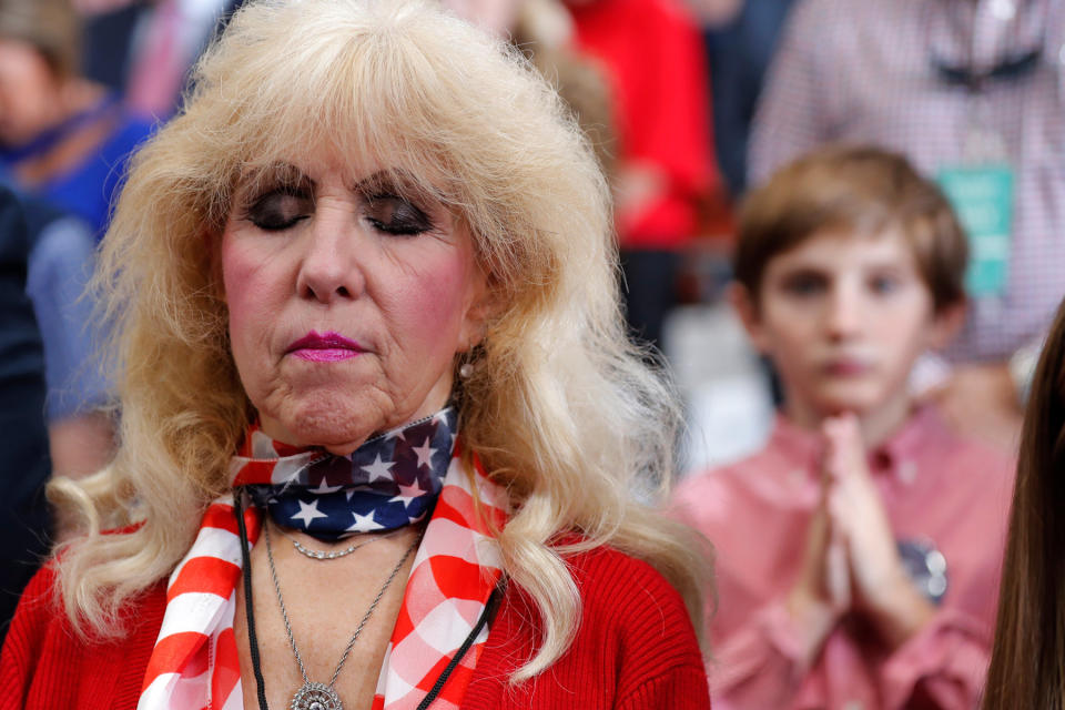 Ahead of President Donald Trump's appearance at a Nov. 6 campaign rally in Monroe, La., with Republican gubernatorial hopeful Eddie Rispone, supporters pray during an invocation.