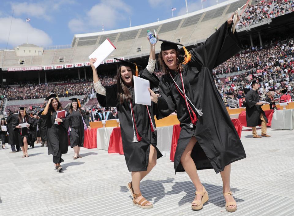 After receiving their B.S. in nursing degrees, Abby Broyles, center, and Talor Brokamp celebrate during spring commencement in 2019 at Ohio State University.