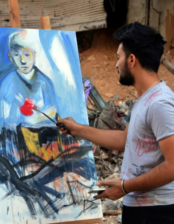 Artist Abdallah al-Harith, 21, works on a picture in the Yarmuk Palestinian refugee camp on August 15, 2018