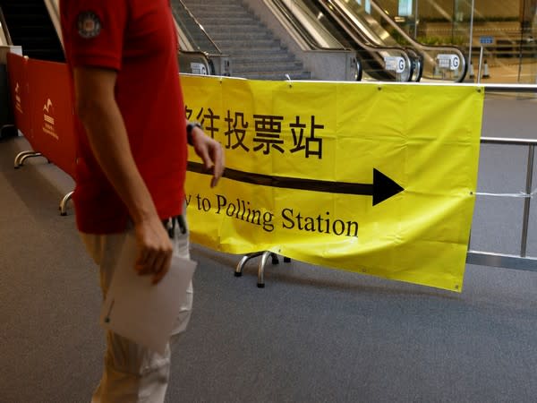  A voter walks into a polling station during the voting of the election committee in Hong Kong. (Photo credit: Reuters)