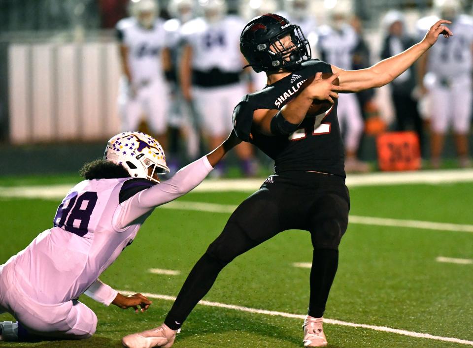 Early defensive back Vic Cooper pulls down Shallowater running back Kalbe Cox by his jersey during their playoff game against Shallowater on Nov. 19 at Clyde. Shallowater won 43-14.