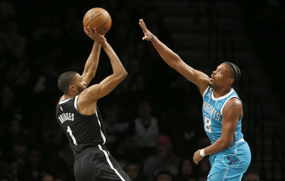 Brooklyn Nets forward Mikal Bridges (1) shoots over Charlotte Hornets guard Dennis Smith Jr. (8) during the first half of an NBA basketball game, Sunday, March 5, 2023, in New York. (AP Photo/John Munson)