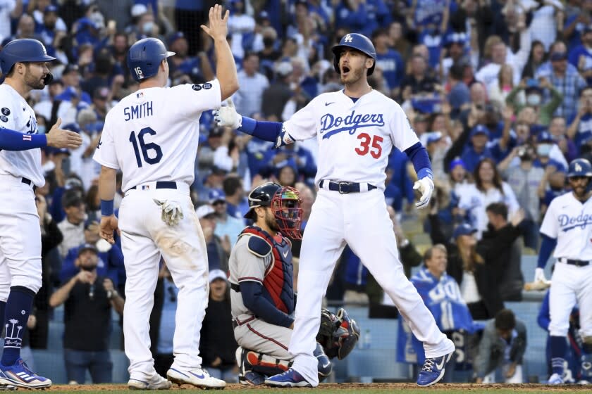 Los Angeles, CA - October 19: Los Angeles Dodgers' Cody Bellinger, right, celebrates with Will Smith and AJ Pollock.