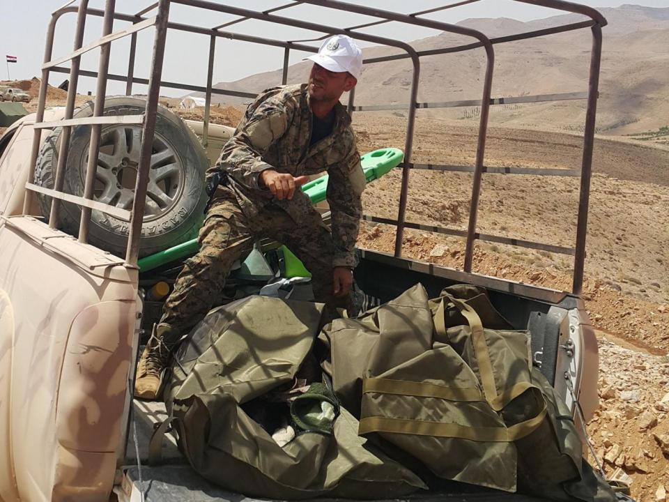 A Syrian officer identifies three dead Isis fighters in body bags at the captured Qalamoun fortress (Nelofer Pazira)