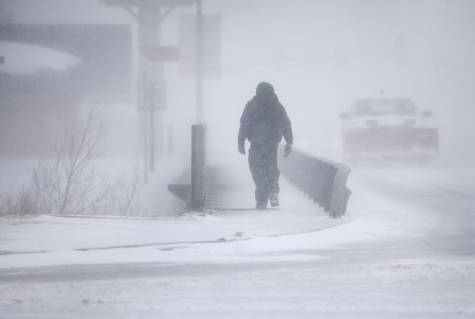 A man crosses Crow Creek during a blizzard on Wednesday, March 13, 2019, in Cheyenne, Wyo. Heavy snow hit Cheyenne about mid-morning Wednesday and was spreading into Colorado and Nebraska. (Jacob Byk/The Wyoming Tribune Eagle via AP)