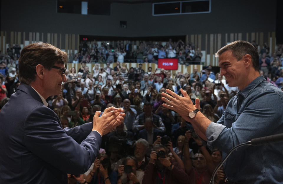 Spanish Prime Minister Pedro Sánchez applauds the socialist candidate, Salvador Illa, left, during a campaign rally in Villanova i la Gertru, near Barcelona, Spain, Thursday, May 9, 2024. Some nearly 6 million Catalans are called to cast ballots in regional elections on Sunday that will surely have reverberations in Spain's national politics. (AP Photo/Emilio Morenatti)