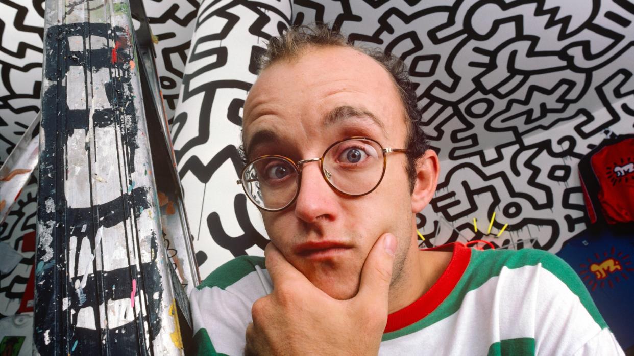  Keith Haring stands in front of his art in 1986. 