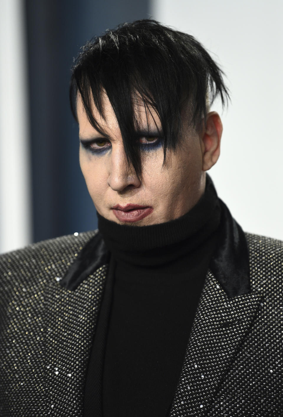 FILE - Marilyn Manson arrives at the Vanity Fair Oscar Party on Feb. 9, 2020, in Beverly Hills, Calif. On Friday, July 2, 2021, Manson, born Brian Hugh Warner, turned himself in to law enforcement in Los Angeles, in relation to a 2019 arrest warrant for acts alleged to have occurred while performing a concert in Gilford, NH. Warner was processed and released on personal recognizance bail. (Photo by Evan Agostini/Invision/AP, File)