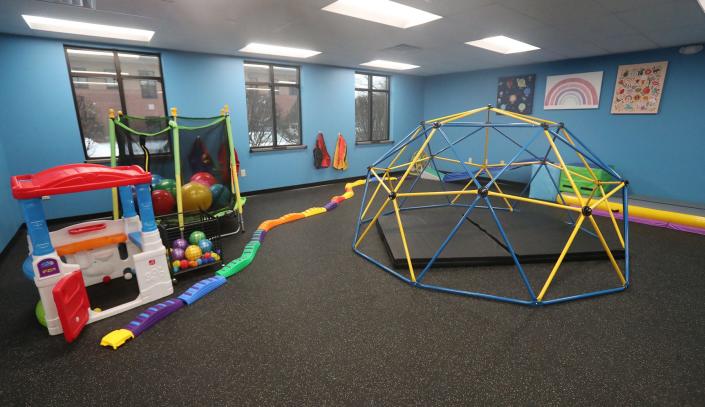 The autism center in Fairlawn includes interactive play areas like this gym, plus a cafeteria, a miniature city hallway setup and more.