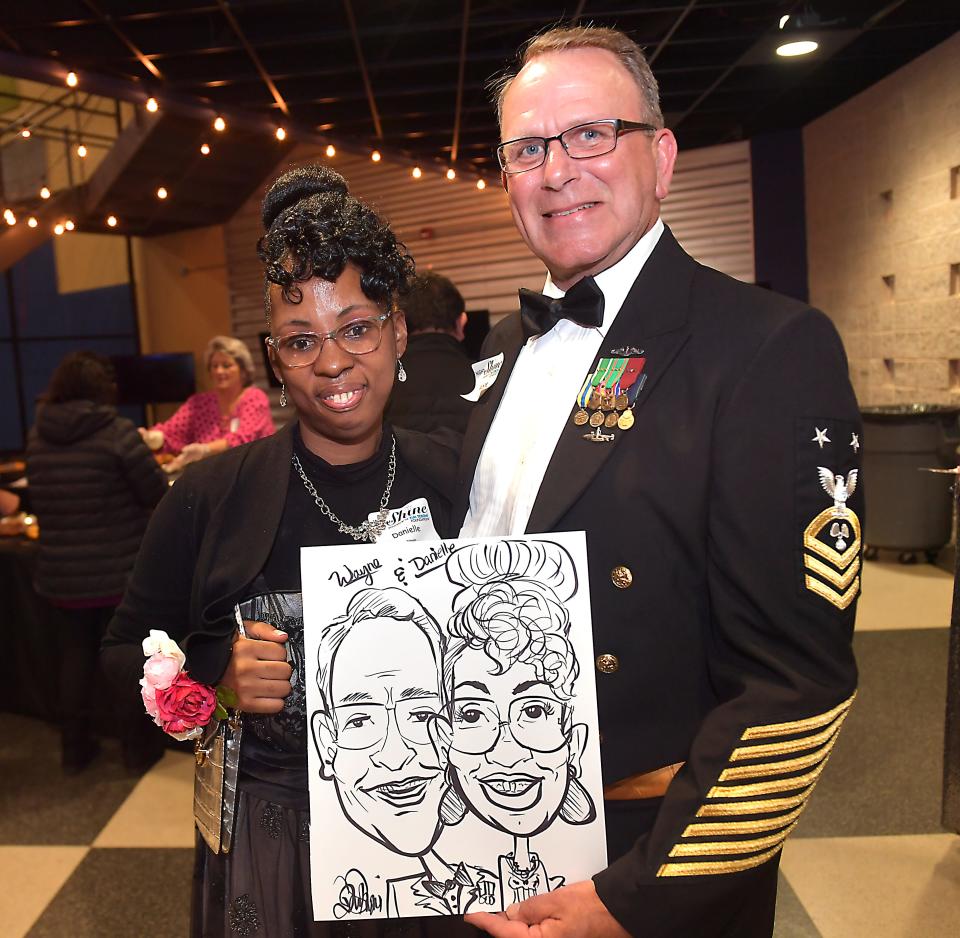 First Baptist Spartanburg joined with the Tim Tebow Foundation to host its annual 'Night to Shine Prom' event for adults with special needs. The event was held at the 'Hangar' in downtown Spartanburg on Feb. 9, 2024. Danielle Johnson, left, with her escort Wayne Maynor in his U.S. Navy Dinner Dress Uniform.