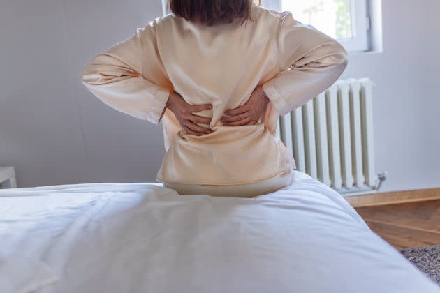 More and more people are saying that back pain, calf pain and odd muscle aches are a significant symptom when they're sick with COVID-19. (Photo: PixelsEffect via Getty Images)