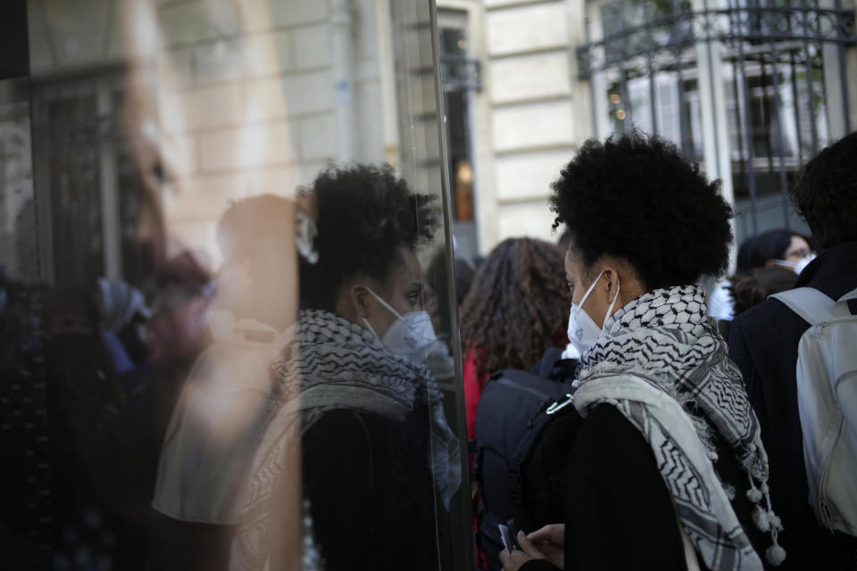 Students gather near Sciences Po university Friday, May 3, 2024 in Paris. French police peacefully evacuated dozens of students from a building of the Paris Institute of Political Studies, known as Sciences Po, who had gathered there in support of Palestinians, echoing similar encampments and solidarity demonstrations across the United States. (AP Photo/Christophe Ena)