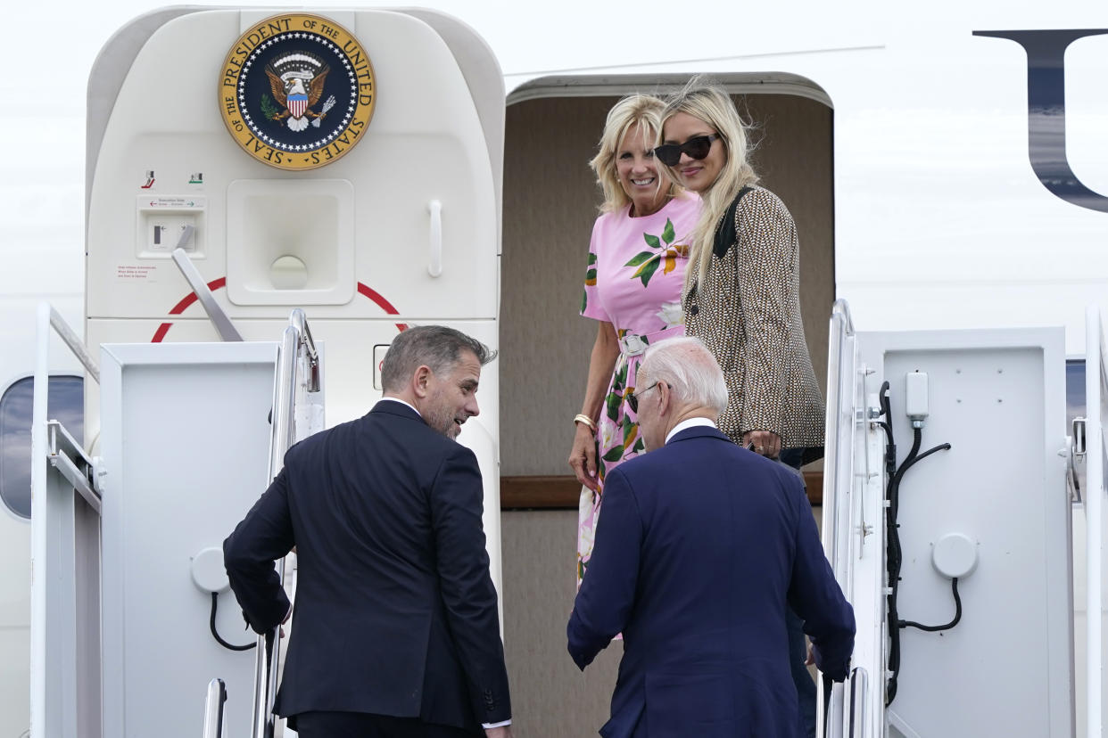 President Joe Biden, lower right, talks with his son Hunter Biden, lower left, as they walk up the steps with first lady Jill Biden, top left, and daughter-in-law Melissa Cohen, top right, to Air Force One at Andrews Air Force Base, Md., Wednesday, Aug. 10, 2022. They are heading to South Carolina for a week-long vacation on Kiawah Island. (AP Photo/Susan Walsh)