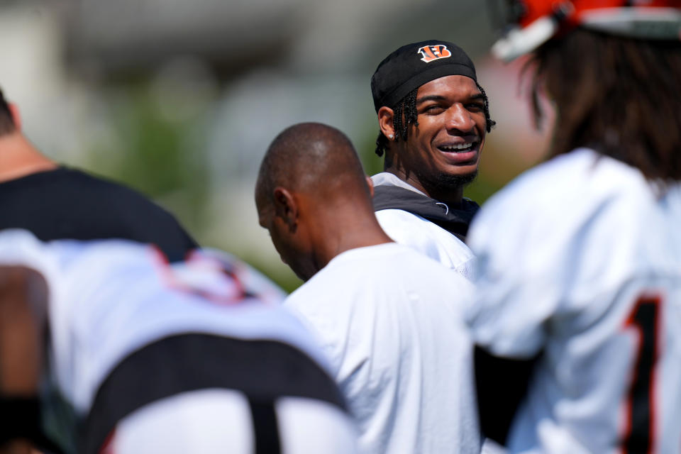 July 31, 2023; Cincinnati, OH, USA; Cincinnati Bengals wide receiver Ja’Marr Chase (1) looks back and smiles after talking with Cincinnati Bengals wide receiver Tyler Boyd (83) (not pictured) during NFL training camp practice, Monday, July 31, 2023, in Cincinnati. Mandatory Credit: Kareem Elgazzar-USA TODAY Sports