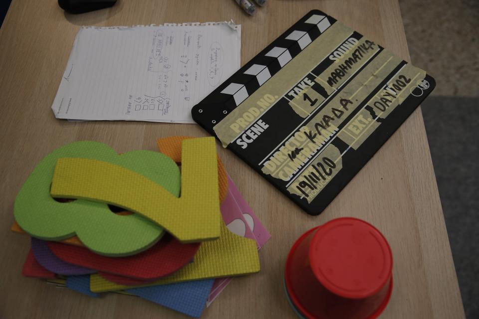 Numbers and notes are placed on a desk before the recording of lessons that are broadcast on public television, at an elementary school in Athens, Wednesday, Nov. 18, 2020. Most other European countries have vowed to keep schools open, but the pandemic has hit Greece hard for the first time in recent weeks following a successful lockdown in the spring, overwhelming hospitals in parts of the country. State television is making and broadcasting lessons, while teachers sit in empty classrooms talking to remote students. Despite some problems, they say it keeps children in touch with their schools. (AP Photo/Thanassis Stavrakis)