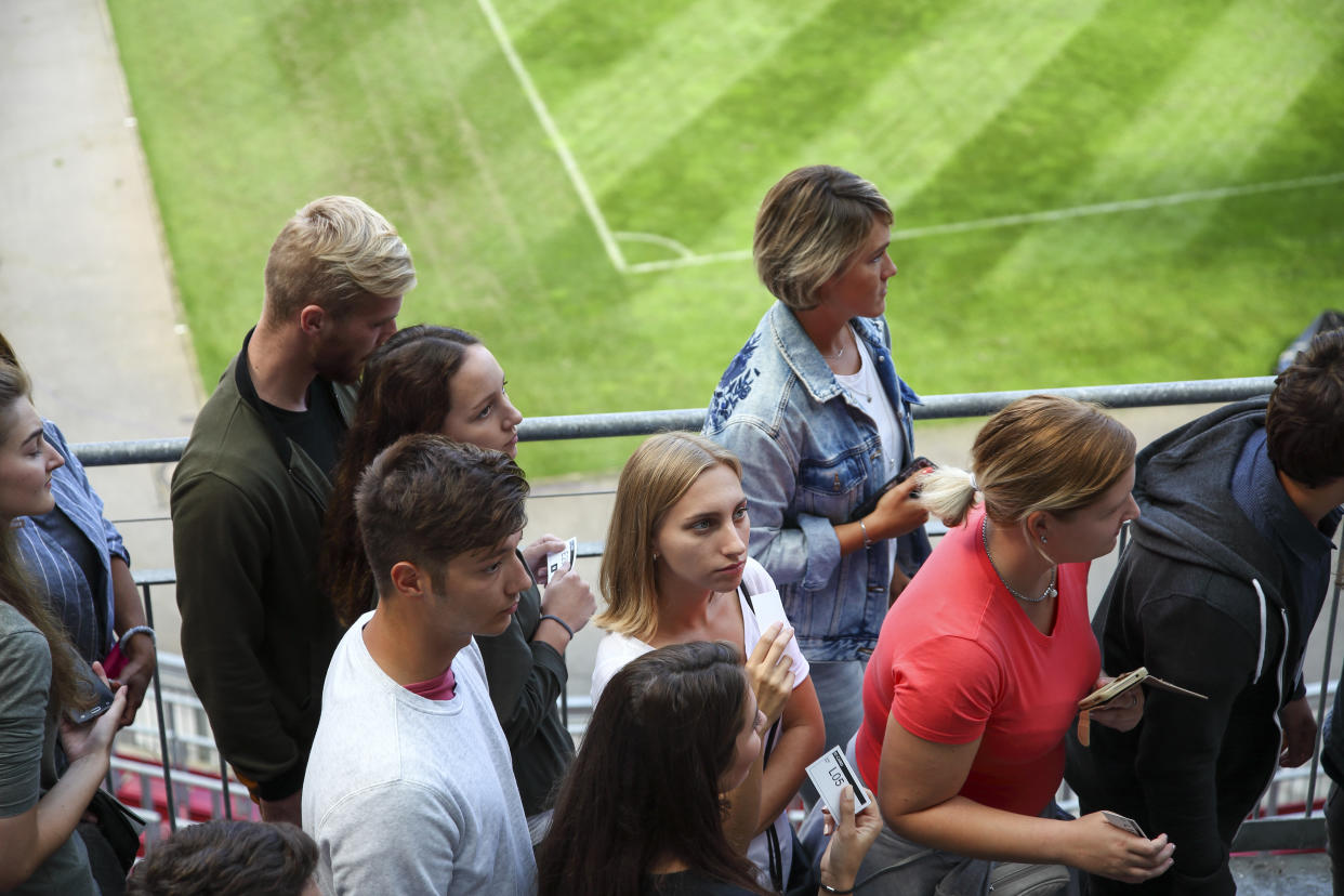 Line of people on the stadium gates, waiting to get to their seats.