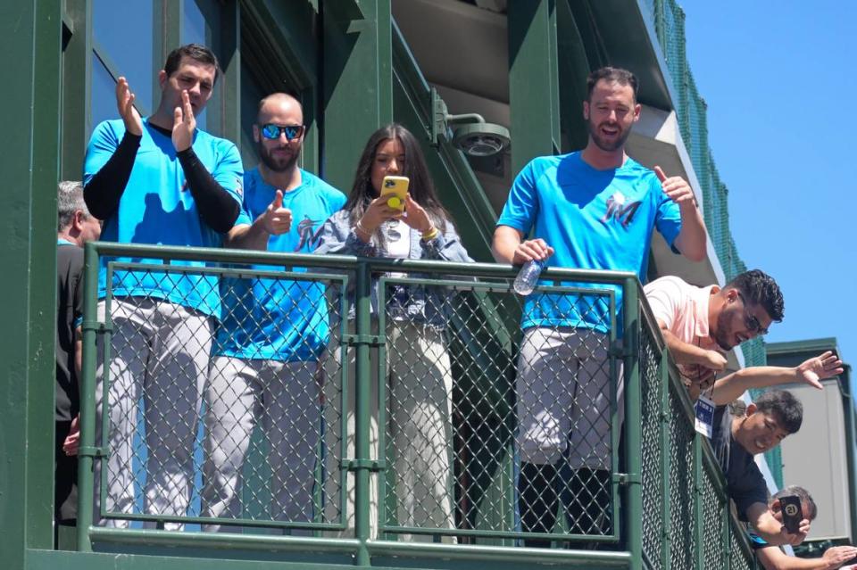 Miami Marlins players and staff members cheer on the team’s nine rookies as they return to Wrigley Field after making a Dunkin’ Donuts run prior to their game against the Chicago Cubs on Saturday, June 19, 2021, in Chicago.