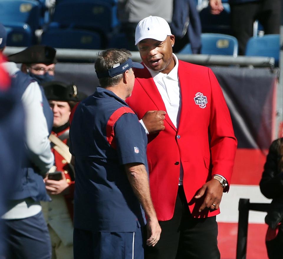 Patriots head coach Bill Belichick shares a moment with former Patriots defensive end Richard Seymour before the game against the Jets. Richard has just been inducted into the Patriots Hall of Fame and will be honored during a halftime ceremony.[The Providence Journal/Bob Breidenbach]