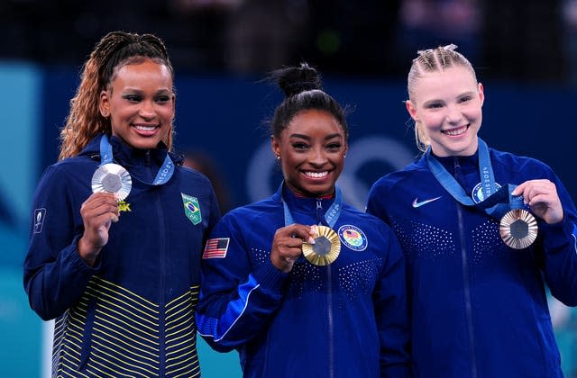 Simone Biles, centre, with fellow medallists Rebeca Andrade, left, and Jade Carey 