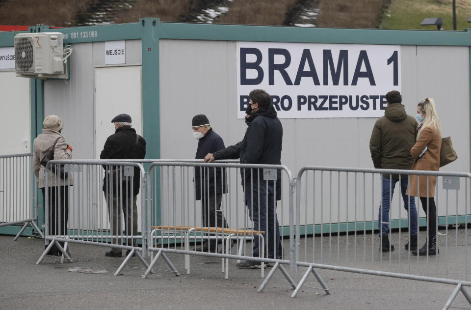 Elderly people wait in line to be vaccinated against COVID-19 at the temporary hospital at the National Stadium in Warsaw, Poland, on Monday, Jan. 25, 2021. Overload of online registration system and reduced deliveries of the Pfizer vaccines are causing delays in the national inoculation procedure that currently aims at vaccinating people aged over 70. (AP Photo/Czarek Sokolowski)